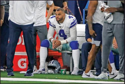 DALLAS COWBOYS quarterback Dak Prescott (4) sits on the bench by staff late in the second half of an NFL game against the Buffalo Bills in Arlington, Texas, Thursday. The Cowboys lost 26-15. (AP Photo)