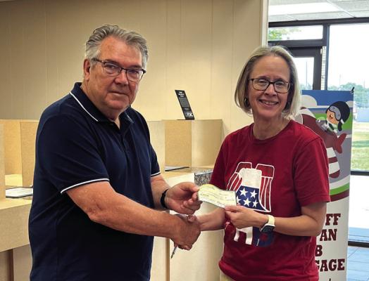 THE PONCA City Vietnam Veterans of America (VVA) donated $766 to the Barnsdall Tornado Relief Fund. A presentation was made to Karen Overacker (right) with the American Heritage Bank in Barnsdall. She is pictures with Bob Reiners, VVA VVA Secretary/ Treasurer. (Photo Provided)