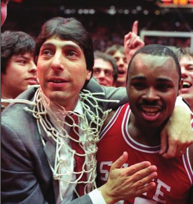 COACH JIM VALVANO and Lorenzo Charles celebrate after North Carolina State upset Houston in the NCAA finals. It was Charles’ last second basket that gave NC State the victory.