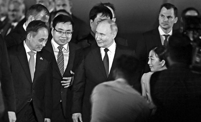 RUSSIA'S PRESIDENT Vladimir Putin, center, walks to a car upon his arrival in Vietnam, at the Noi Bai International Airport in Hanoi on June 20, 2024. (Nhac Nguyen/AFP/Getty Images/TNS)