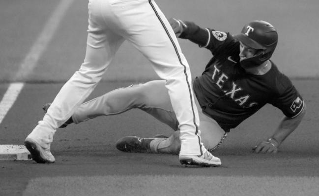 TEXAS RANGERS’ Wyatt Langford slides in safely beneath Baltimore Orioles third baseman Jordan Westburg on Sunday, June 30, 2024, at Oriole Park at Camden Yards in Baltimore. (Karl Merton Ferron/The Baltimore Sun/TNS)